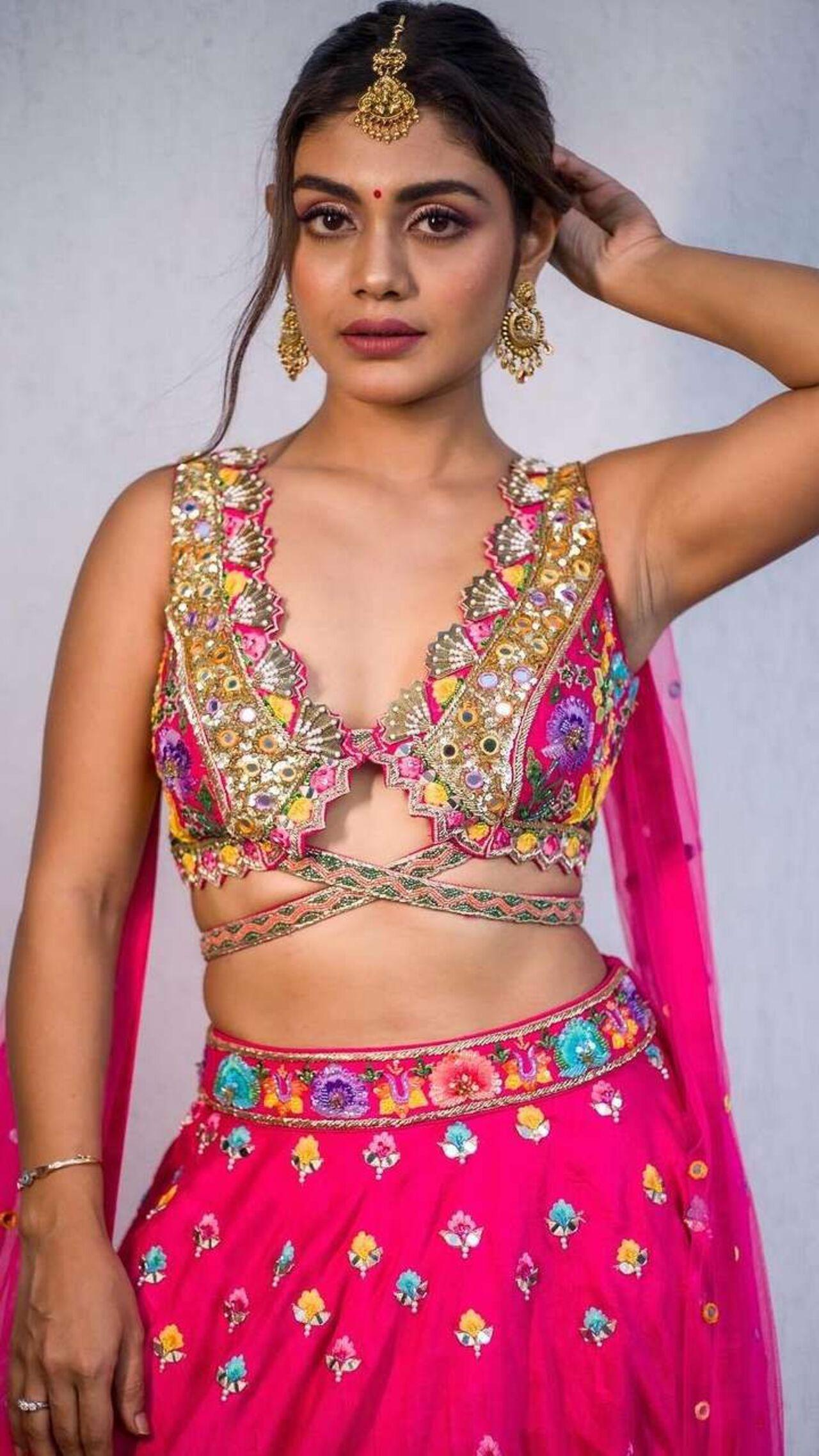 Sreejita looks gorgeous in this fuchsia pink lehenga. But the cutout embellished blouse steals the show along with her maang tika and heavy earrings.